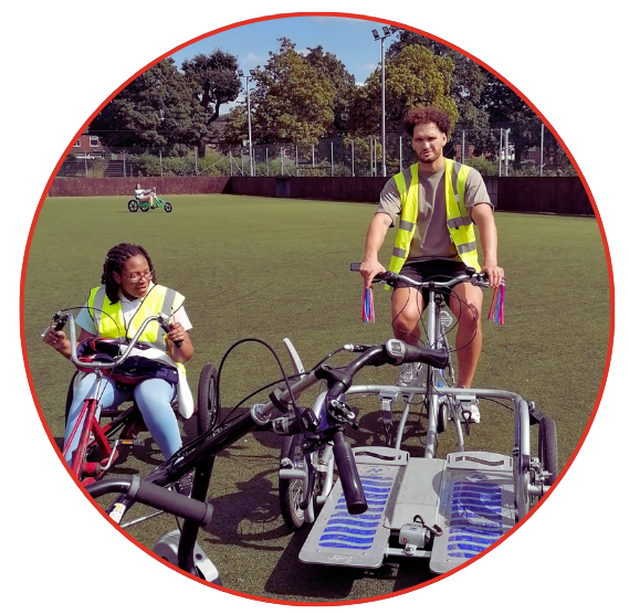 Two individuals on bicycles enjoy a sunny day in a field