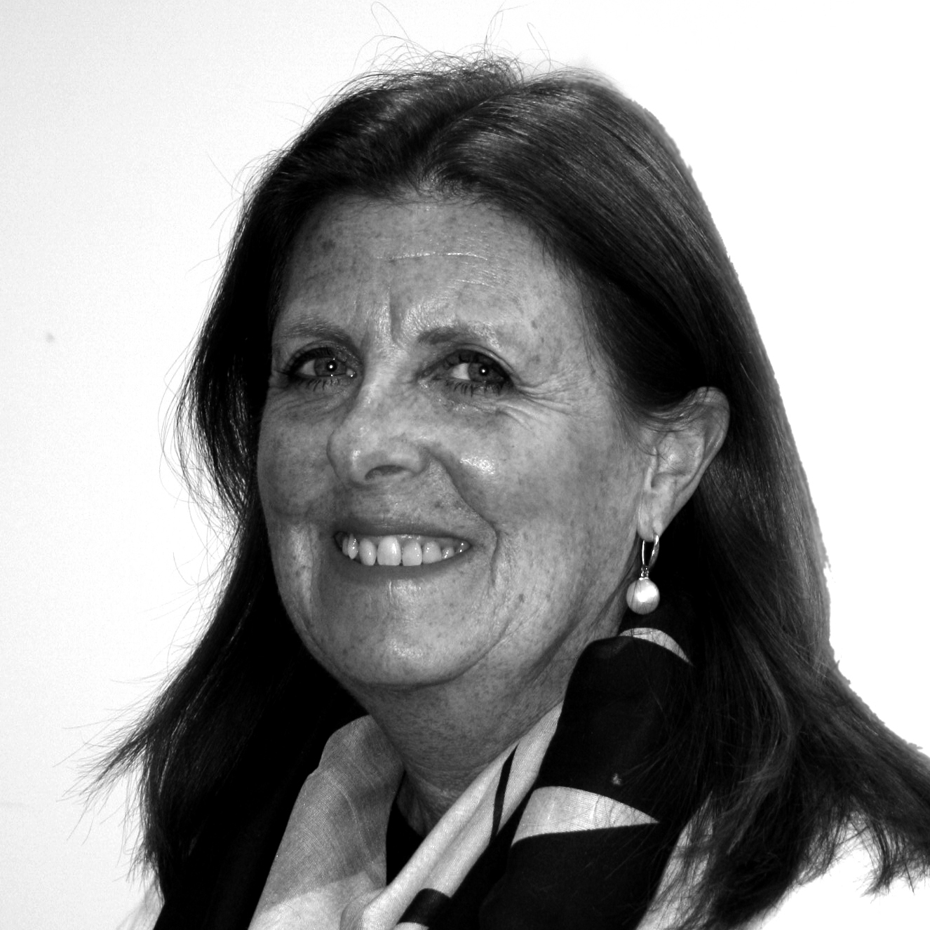 A black and white image of a woman smiling warmly, capturing a moment of joy and positivity.